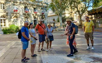Tour group with guide in front of Popes' Palace, Avignon.