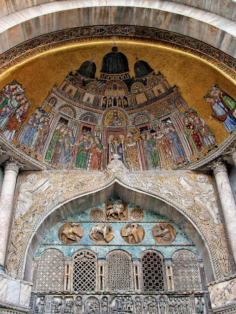 St. Mark’s Basilica interior with ornate mosaics and columns, Venice, Italy.