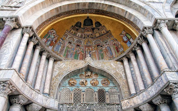 St. Mark’s Basilica interior with ornate mosaics and columns, Venice, Italy.