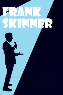 Frank Skinner performing on stage at a comedy show in London.