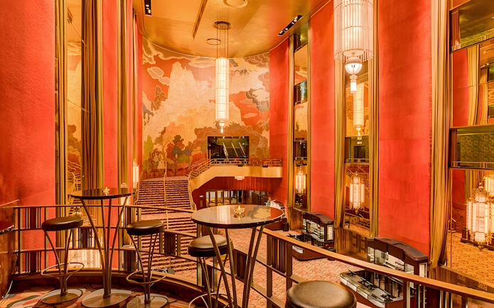 Radio City Music Hall interior with art deco design and grand staircase.