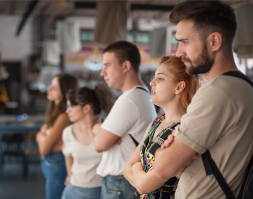 Visitors observing artwork in a modern gallery setting.