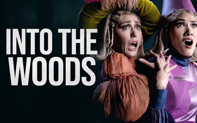 Actors in costume express surprise in a scene from "Into the Woods" musical.