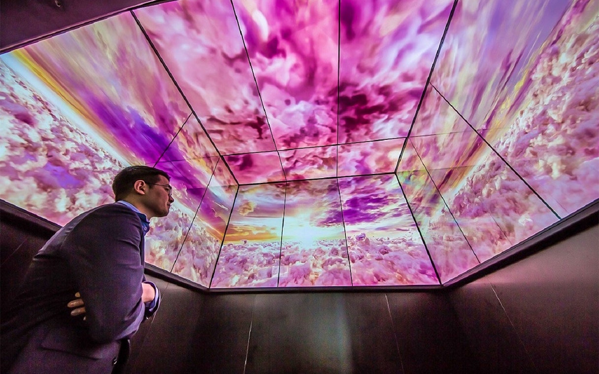 Man viewing digital sky display at Lotte World Tower Seoul Sky.