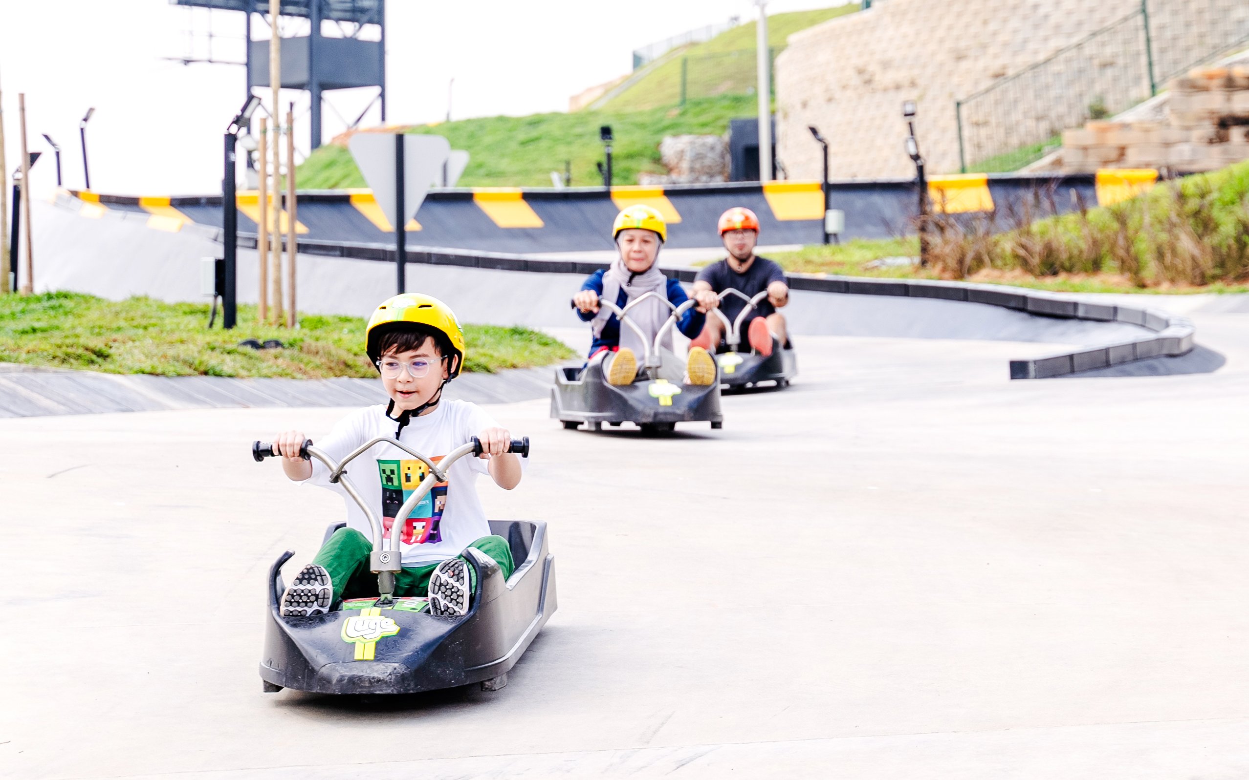 Children riding luge carts on a Skyline Luge track.