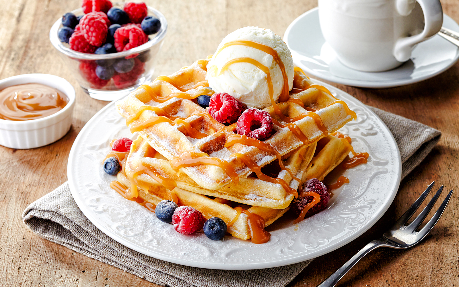 Waffles with berries and ice cream at Escribà, served with caramel sauce.