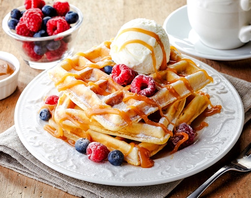 Waffles with berries and ice cream at Escribà, served with caramel sauce.