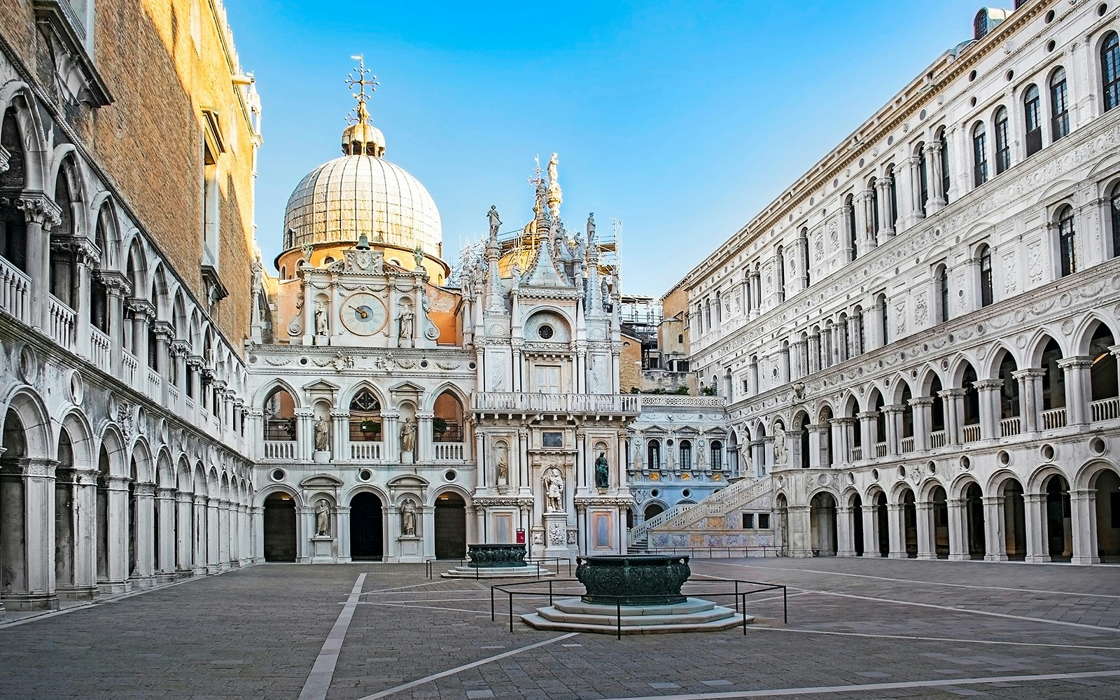 Courtyard of the Doge's Palace in Venice with ornate architecture and central fountain.