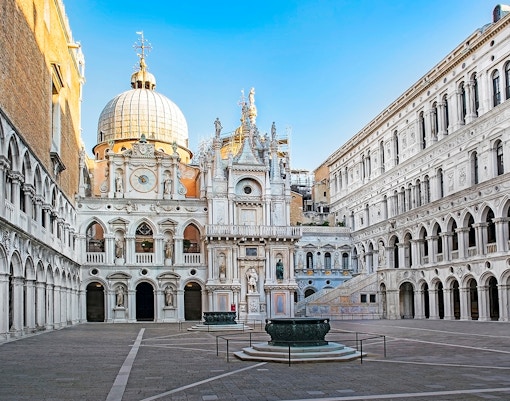 Courtyard of the Doge's Palace in Venice with ornate architecture and central fountain.