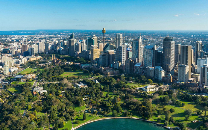 Aerial view of Sydney skyline with Sydney Tower, highlighting SkyFeast dining experience.