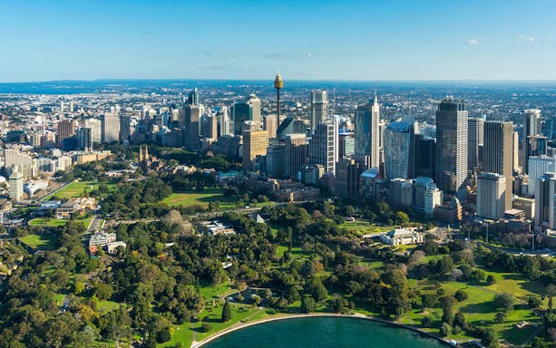 Aerial view of Sydney skyline with Sydney Tower, highlighting SkyFeast dining experience.