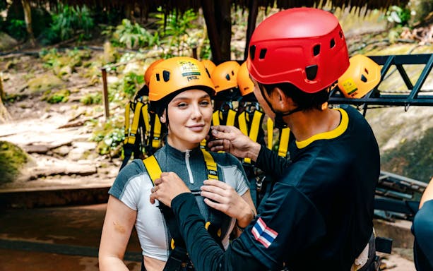 Zipline guide assisting participant with harness at Flying Hanuman, Phuket.