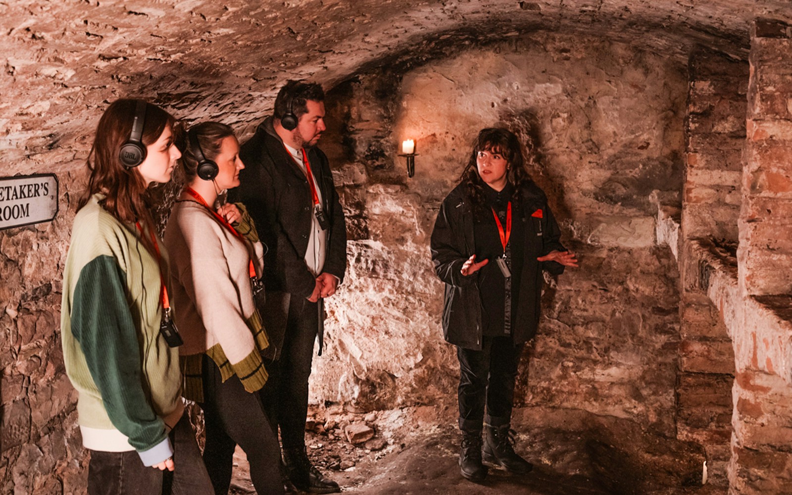 Guide explaining to guests in historic underground vaults tour.
