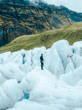 Explorer navigating ice formations in Skaftafell, Iceland.
