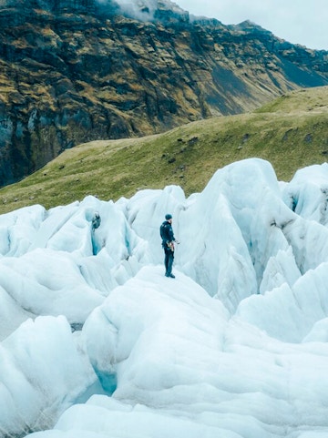 Explorer navigating ice formations in Skaftafell, Iceland.