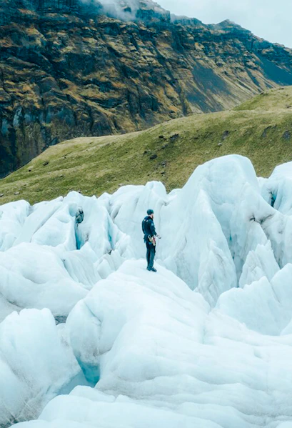 Explorer navigating ice formations in Skaftafell, Iceland.