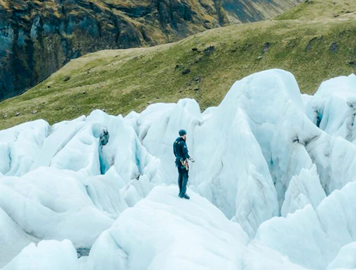 Explorer navigating ice formations in Skaftafell, Iceland.