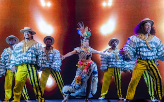 Performers in vibrant costumes dancing at Rio Scenarium, Rio de Janeiro.