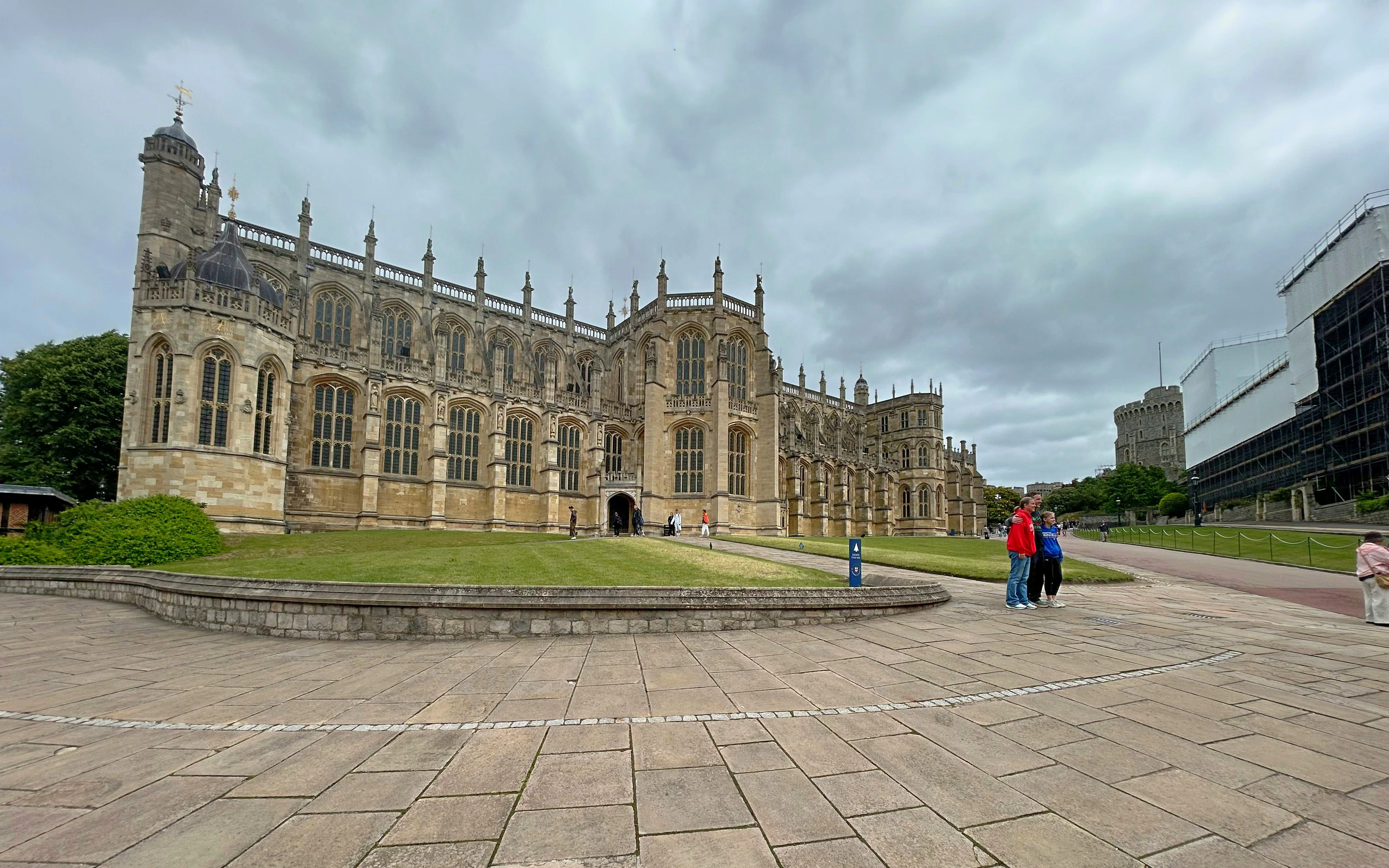 St George's Chapel at Windsor Castle with visitors walking nearby.
