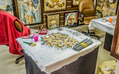 Mosaic art workshop in Madaba, featuring tools and artwork in progress.