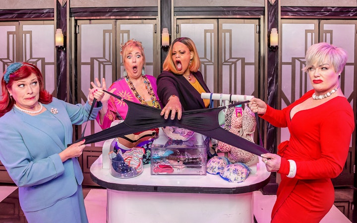 Women in a comedic scene from Menopause the Musical, holding oversized underwear.