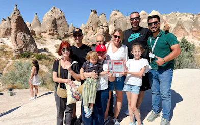 Group of tourists at Zelve Valley rock formations during Cappadocia Red Tour, Turkey.