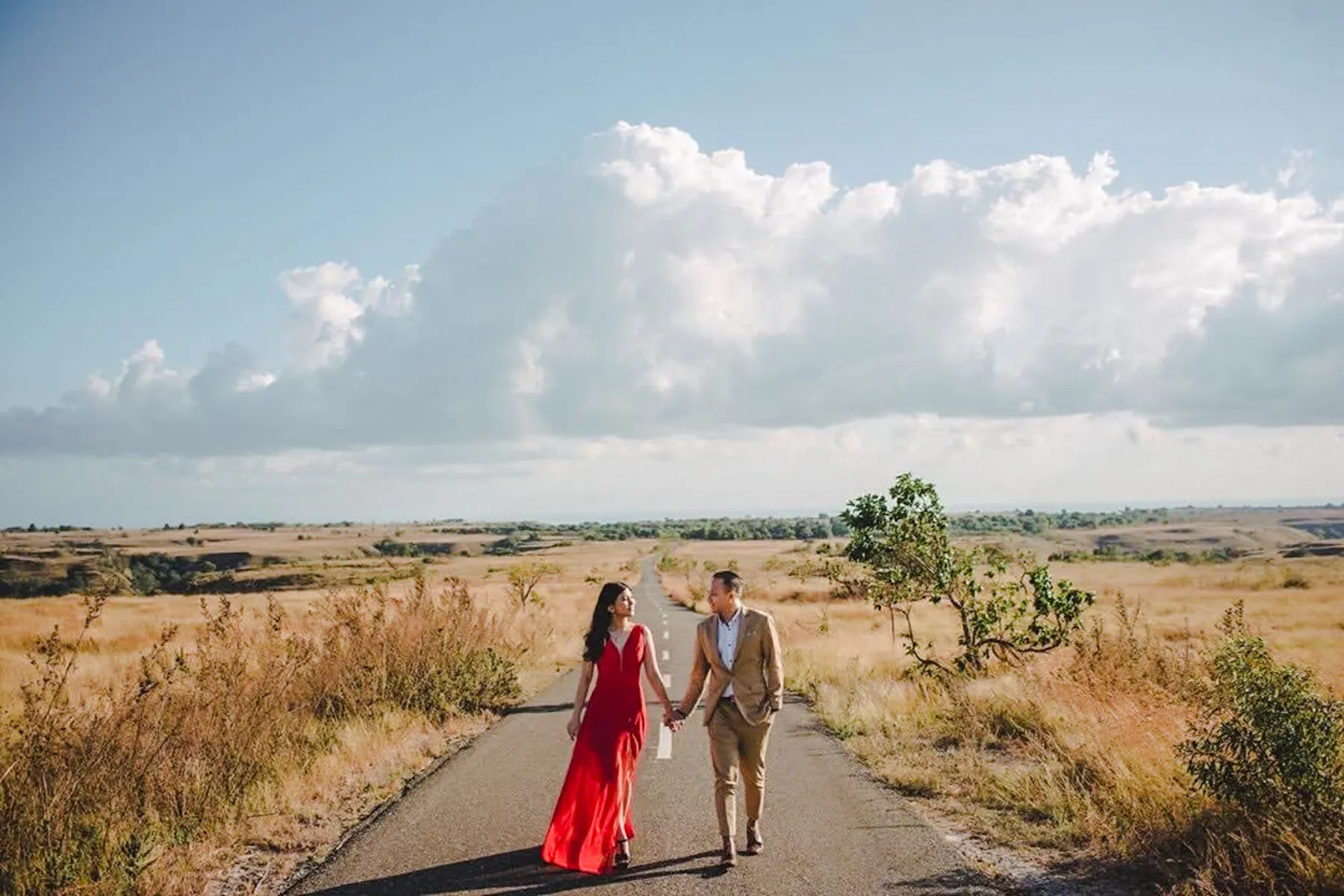 Couple walking on a rural road in Lombok during a professional photoshoot.