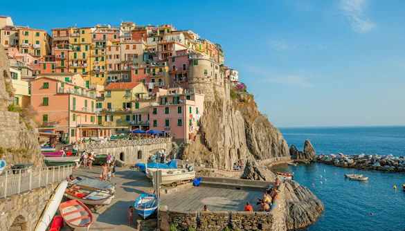 Colorful buildings on a cliffside in Manarola village, Cinque Terre, Italy, overlooking the sea.