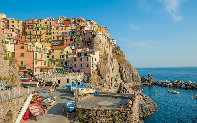 Colorful buildings on a cliffside in Manarola village, Cinque Terre, Italy, overlooking the sea.