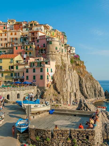 Colorful buildings on a cliffside in Manarola village, Cinque Terre, Italy, overlooking the sea.