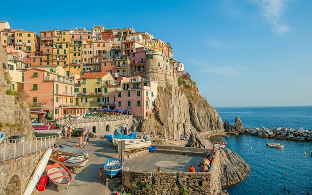 Colorful buildings on a cliffside in Manarola village, Cinque Terre, Italy, overlooking the sea.
