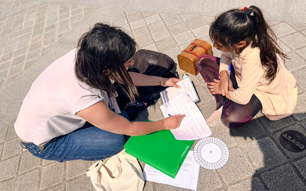 Participants solving clues during Treasure Hunt tour from Panthéon to Louvre.