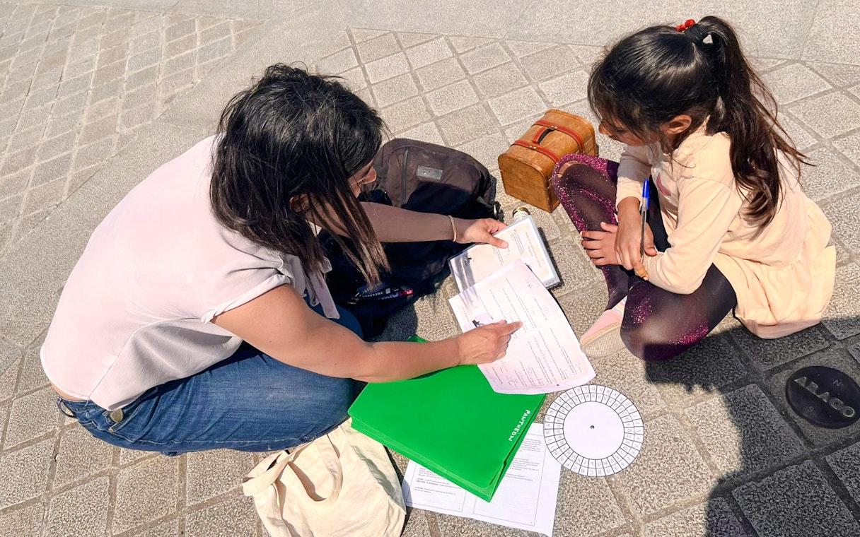 Participants solving clues during Treasure Hunt tour from Panthéon to Louvre.