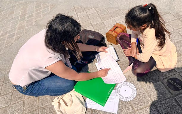 Participants solving clues during Treasure Hunt tour from Panthéon to Louvre.