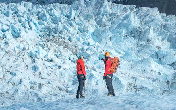 Tour guide explaining glacier features to guests during Blue Ice Experience at Skaftafell.