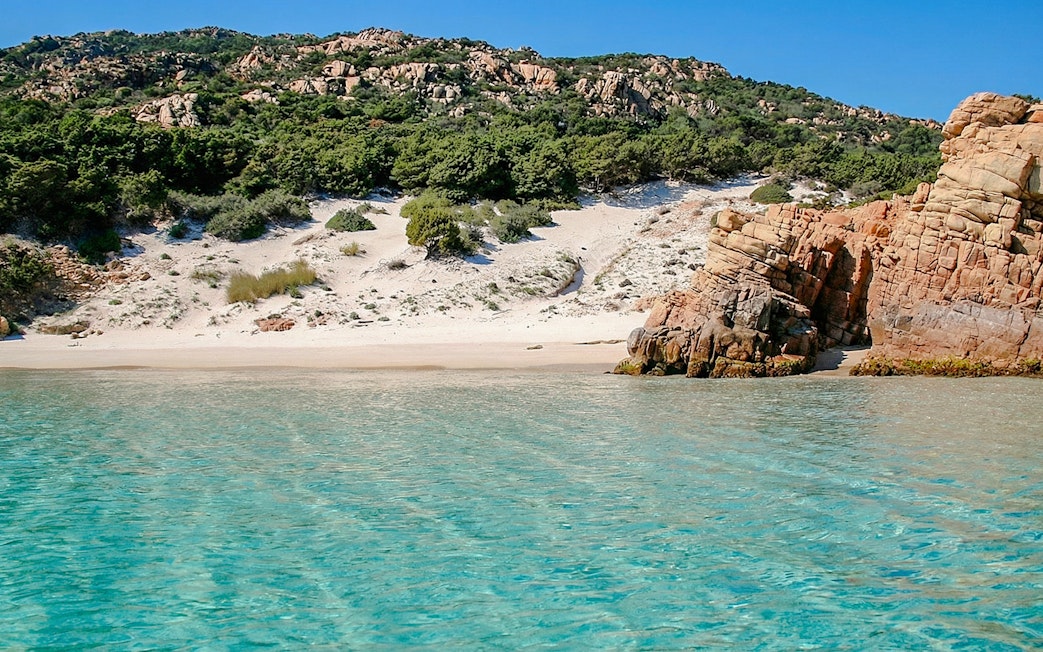 Sandy beach and rocky coastline of La Maddalena Archipelago, Sardinia.