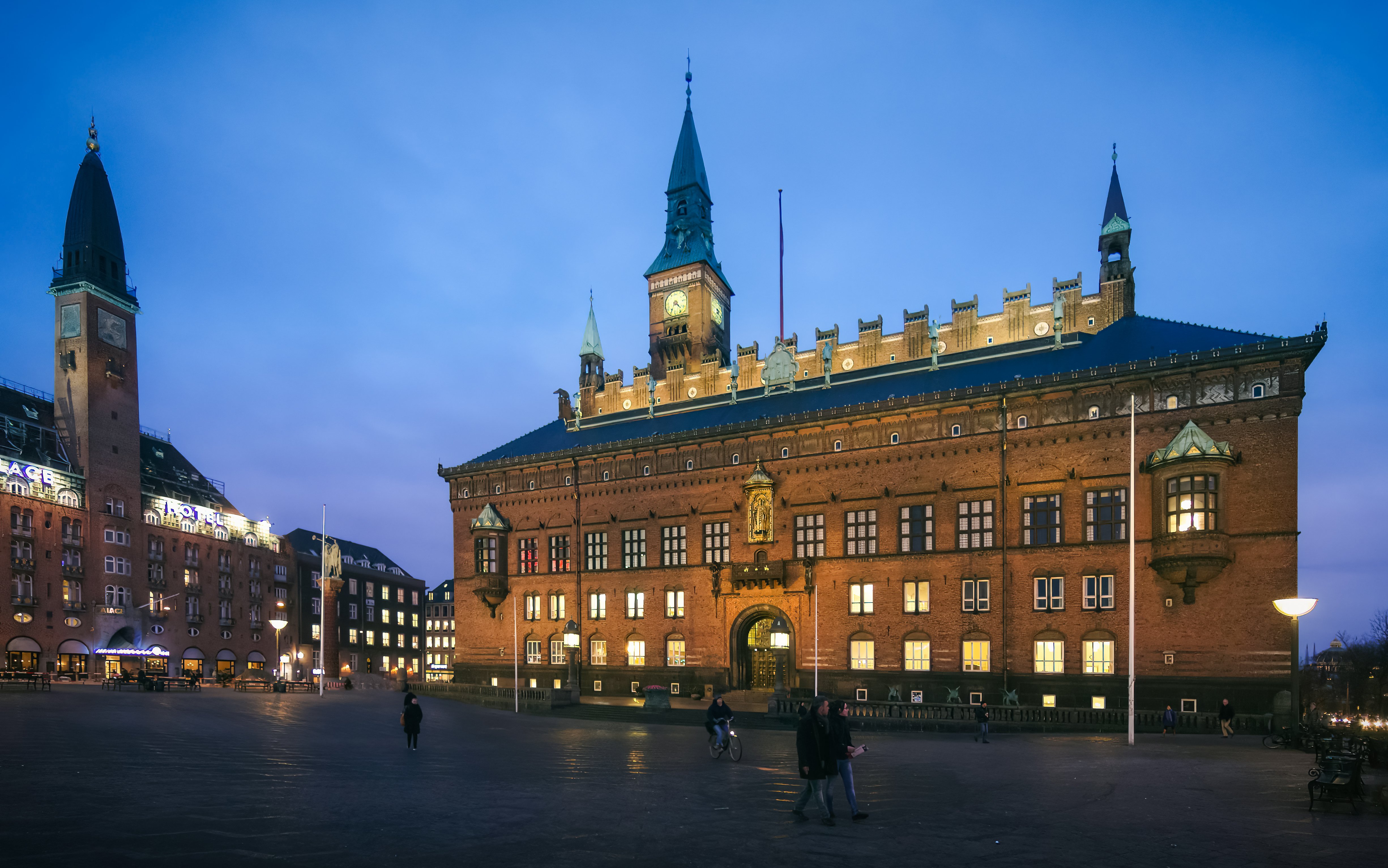 Copenhagen City Hall illuminated at dusk in City Hall Square.