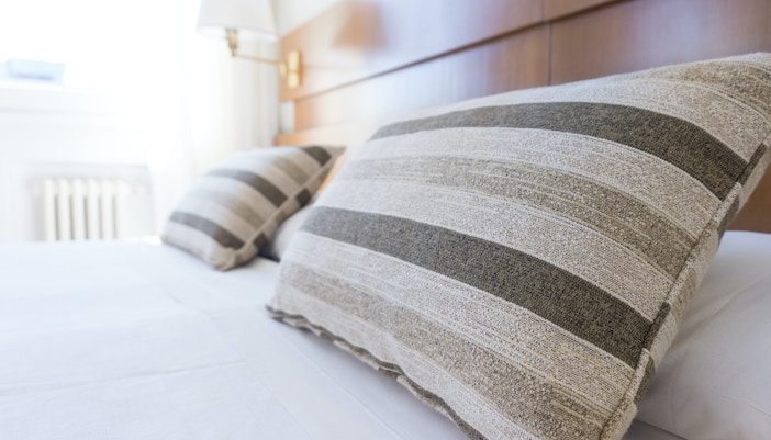 Striped pillows on a bed at Z Hotel Soho, London’s theatre district.
