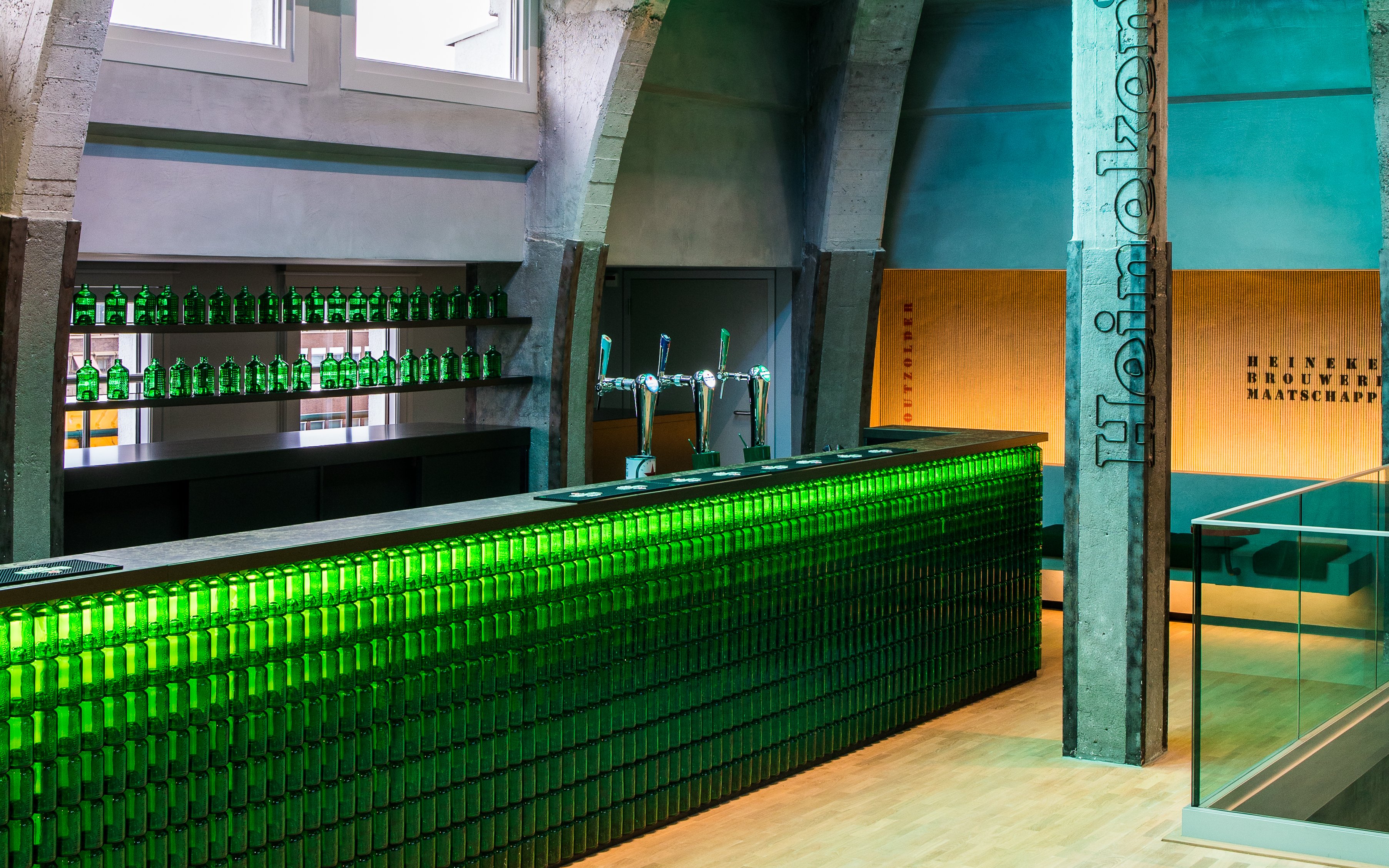 Heineken bar with green bottles and taps at rooftop experience in Amsterdam.