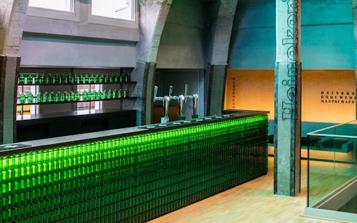 Heineken bar with green bottles and taps at rooftop experience in Amsterdam.