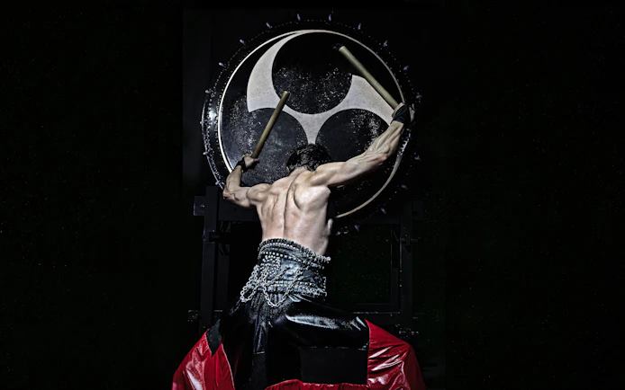 Performer playing large drum at DRUM TAO Theater Kyoto.