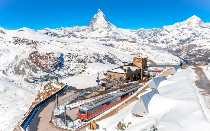 Gornergrat train at Gornergrat Railway Station with Matterhorn in the Swiss Alps.