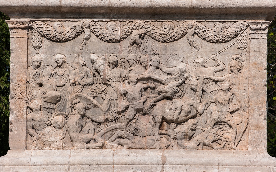 Sculptures depicting historical scenes at Glanum Archaeological Site, France.