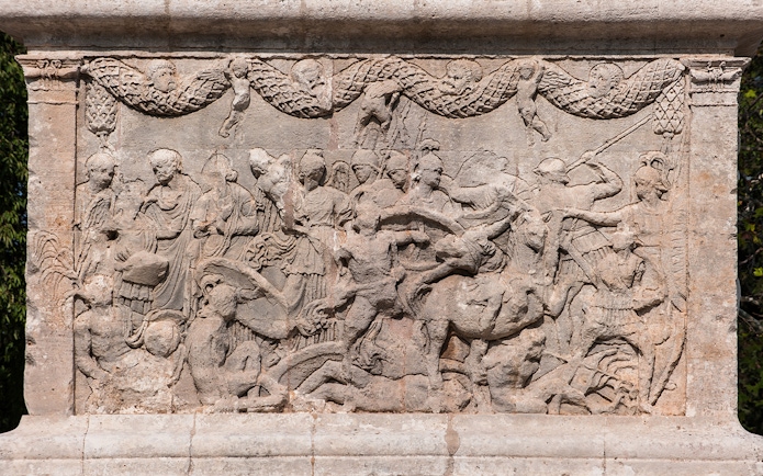 Sculptures depicting historical scenes at Glanum Archaeological Site, France.