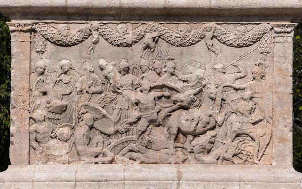 Sculptures depicting historical scenes at Glanum Archaeological Site, France.
