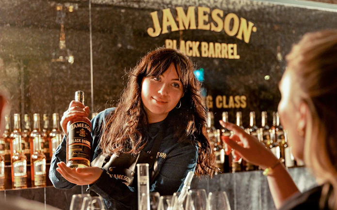 Whiskey expert presenting Jameson Black Barrel during blending masterclass.