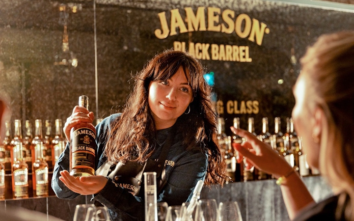 Whiskey expert presenting Jameson Black Barrel during blending masterclass.