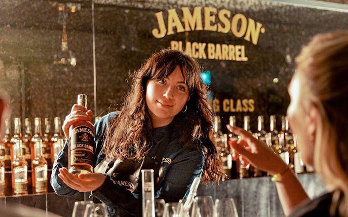 Whiskey expert presenting Jameson Black Barrel during blending masterclass.