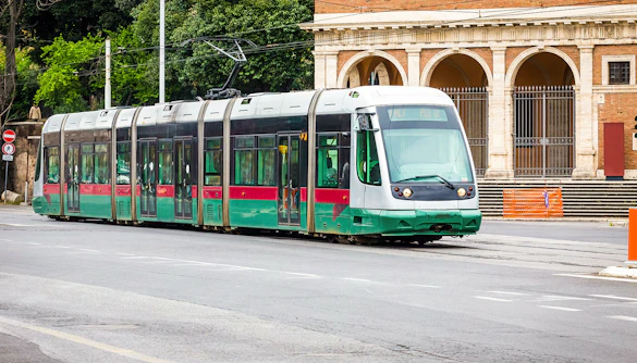 Tram passing by historic building in Rome, Italy.