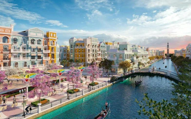 Gondola on canal with colorful buildings and cherry blossoms, Dubai.